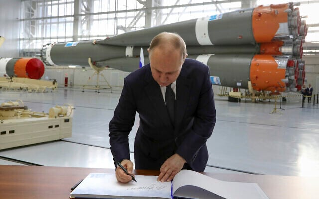 El presidente ruso, Vladimir Putin, firma en el libro de visitas en una fábrica de ensamblaje de cohetes durante su visita al cosmódromo Vostochny en las afueras de la ciudad de Tsiolkovsky, a unos 200 kilómetros (125 millas) de la ciudad de Blagoveshchensk, en la región oriental de Amur Tsiolkovsky, Rusia, abril 12 de febrero de 2022. (Evgeny Biyatov, Sputnik, foto de la piscina del Kremlin vía AP)