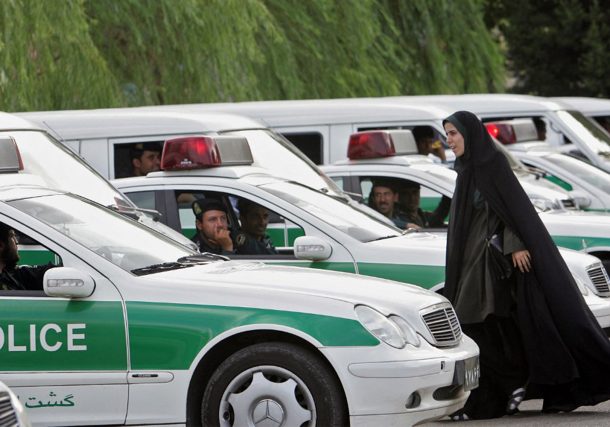 Radio Jai -Archivo: Una mujer policía de moralidad iraní camina entre los vehículos de la policía de moralidad, preparándose para iniciar una represión para hacer cumplir el código de vestimenta islámico en Teherán, 23 de julio de 2007. (Behrouz Mehri/AFP)